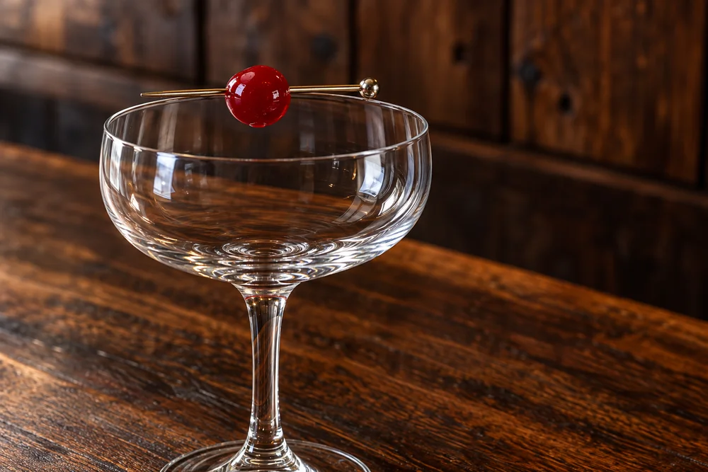 Manhattan · Garnish on a wooden bar