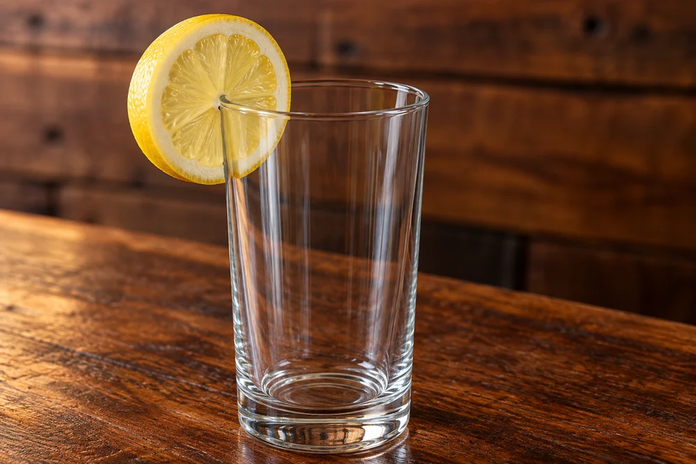 Blue Lagoon · Garnish on a wooden bar