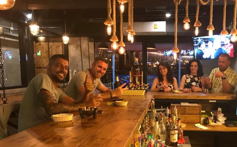 Guests gathered around the wooden bar