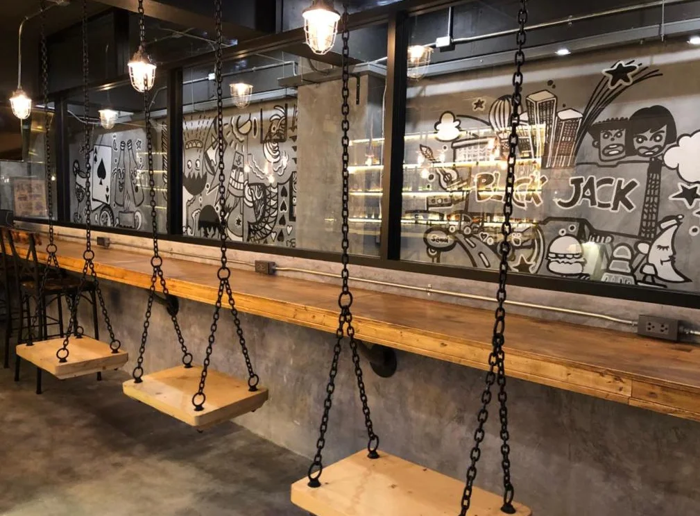 Wooden swings in front of the original Blackjack murals