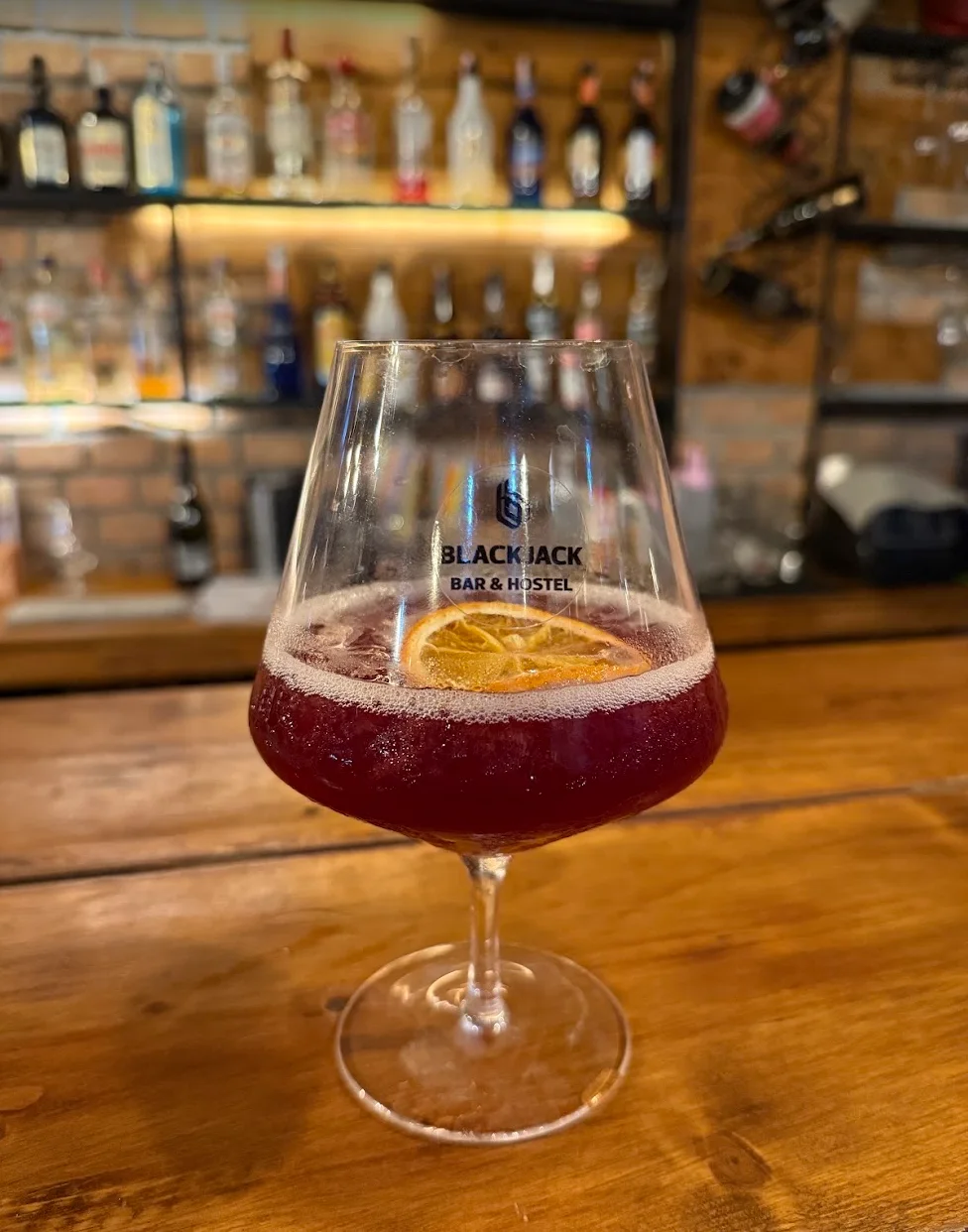 Red cocktail in a branded Blackjack glass