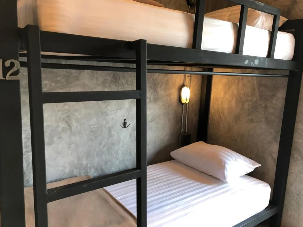 Lower bunk with pillow and bedside light