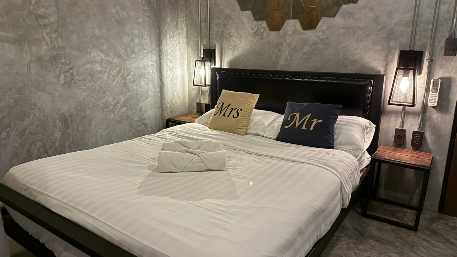 Double bed with white bedding and bedside lamps