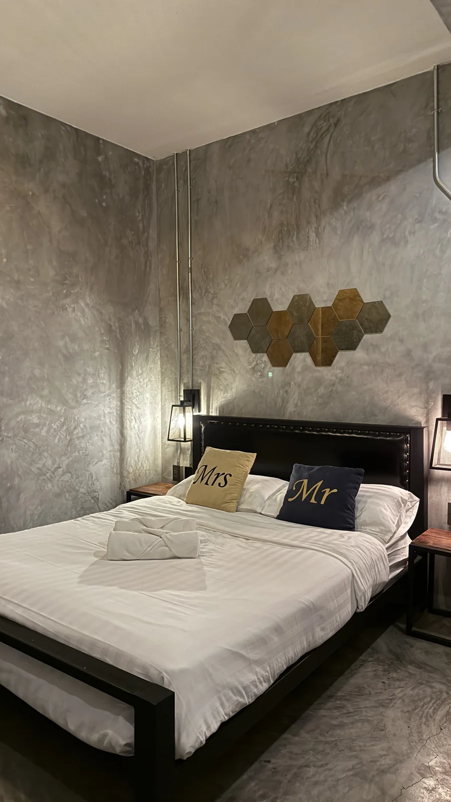 Double bed with white bedding and bedside lamps